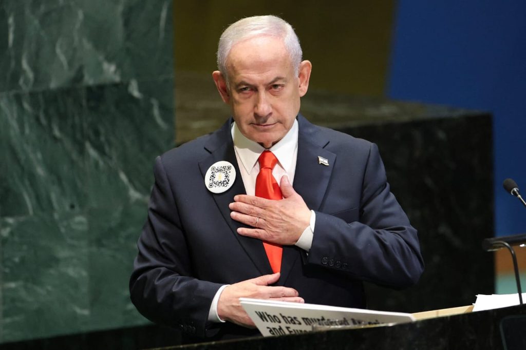 Israeli Prime Minister delivers speech at UN General Assembly 2025 with hand on chest.